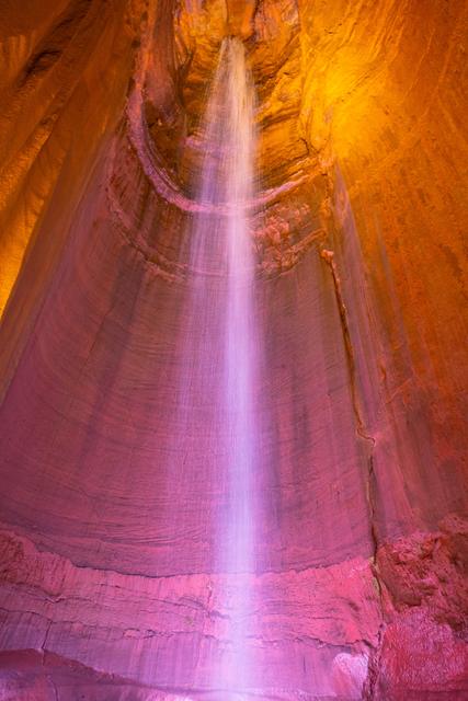 Ruby Falls underground waterfall lit in pink and amber inside Lookout Mountain cave